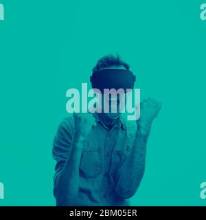 Man in his 30's wearing a VR virtual reality headset. Graphic duotone style Stock Photo