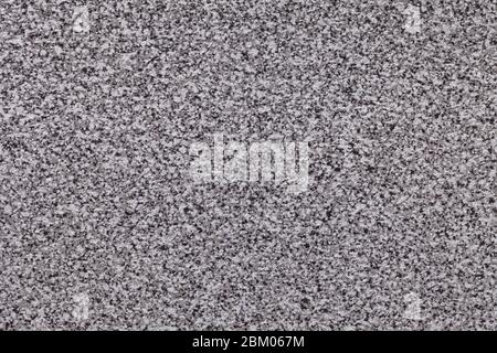 Grainy black background with white and gray spots. Texture backdrop with small crumb pattern for interior design and kitchen countertop. Stock Photo