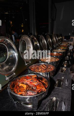 Buffet trays with spicy meat food inside a restaurant. Stock Photo