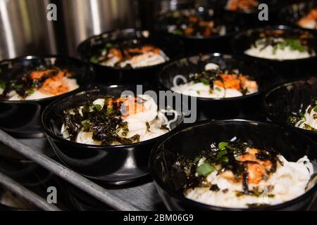 Japanese style udon noodles with seaweed and soft boiled eggs on a buffet restaurant. Stock Photo