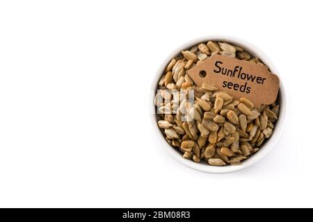 Sunflower seeds in bowl isolated on white background. Top view. Copy space Stock Photo