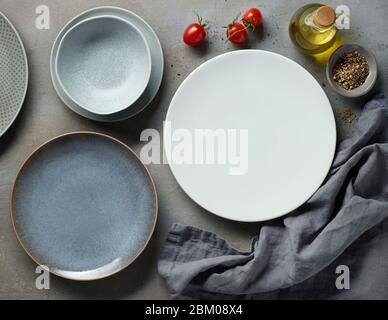various empty plates on grey table, top view Stock Photo