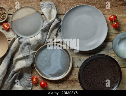 various empty plates on rustic wooden table, top view Stock Photo