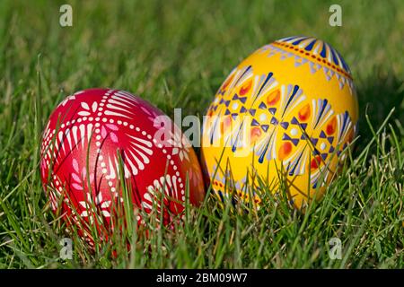 Two hand-painted Easter eggs lie in the grass Stock Photo