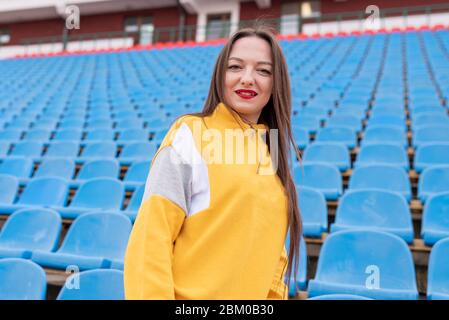 Girl alone in an empty stadium.  Stock Photo