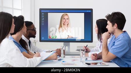 Telemedicine concept. Group of young doctors having online conference in hospital, collage Stock Photo