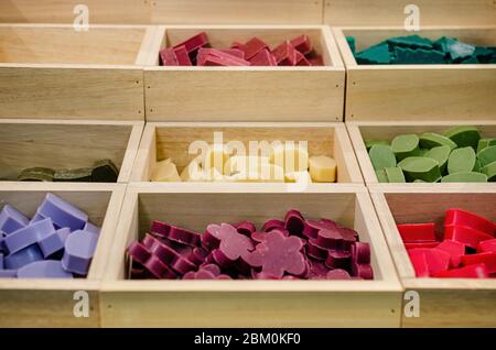 Colorful soaps on a market stall with wooden boxes Stock Photo