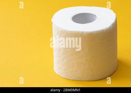 Close-up image of toilet roll isolated on yellow background, copy space for your design or text Stock Photo