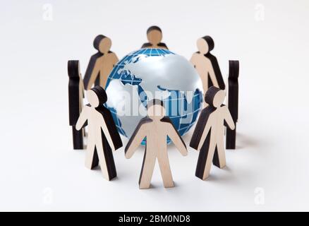 Protect Earth concept. Wooden people figures standing in circle around globe, white background. Collage Stock Photo