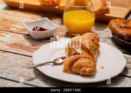 Continental Breakfast With Croissants on Rustic Table Stock Photo