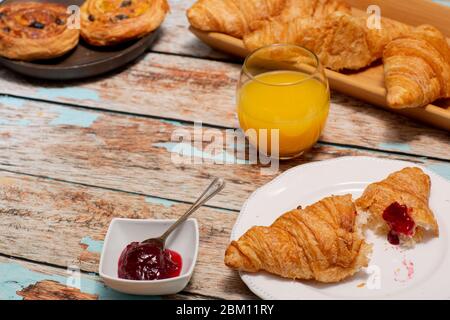 Continental Breakfast With Croissants on Rustic Table Stock Photo