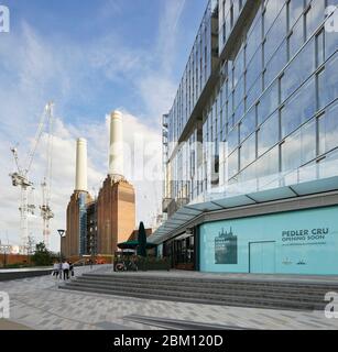 Exterior facade with view of Battersea Power Station. Circus West Village - Battersea Power Station, London, United Kingdom. Architect: simpsonhaugh, Stock Photo