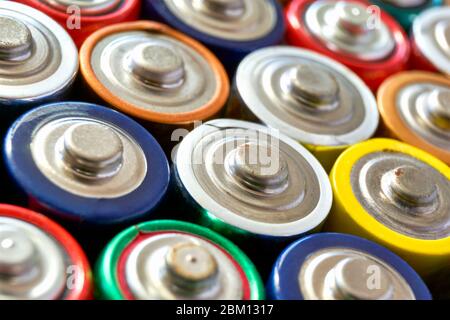 Closeup of group of used disposable AA batteries of various color. Stock Photo