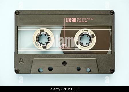 Closeup of plastic audio tape cassette on light blue background. Vintage background. Stock Photo