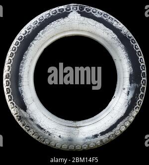 Cutoff of an old car tire , partially painted white Stock Photo