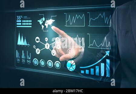 Entrepreneur checking on business data on interactive screen Stock Photo