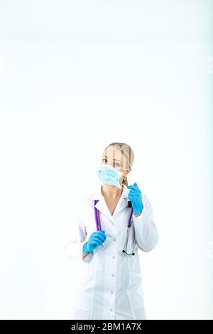 doctor nurse puts on a protective mask. A nurse in a respiratory mask. Put on masks. Wear gloves. beautiful blonde doctor shows how to put on a protec