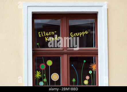 Brandenburg, Germany. 30th Apr, 2020. The window of a day care centre with painted flowers and the lettering 'Parent-Child Group'. Credit: Soeren Stache/dpa-Zentralbild/ZB/dpa/Alamy Live News Stock Photo