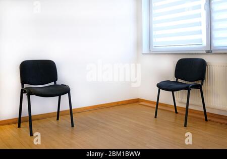 Two chairs in the waiting room of a doctor's office Stock Photo