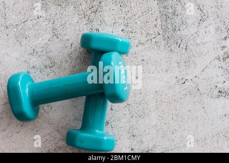 Pair Of Small Dumbbells On Wooden Background. Two Blue Dumbbells On 