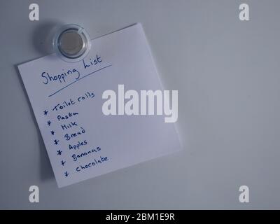 Shopping list on fridge door Stock Photo
