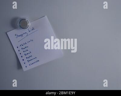 Shopping list on fridge door Stock Photo