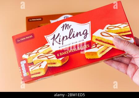Holding a box of Mr Kipling bakewell slices Stock Photo