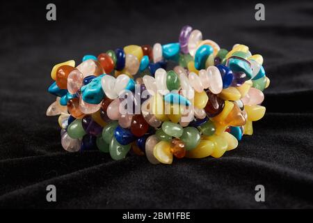 bracelet from different semiprecious stones on black velor. close up Stock Photo