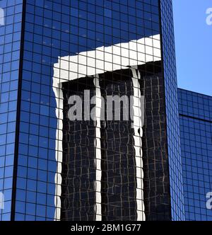 One skyscraper reflected in another on a sunny day in June, Denver, Colorado Stock Photo