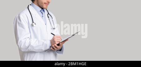 Unrecognizable male therapist writing notes to patient's medical history Stock Photo