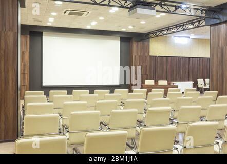 View from seats in auditorium at blank screen Stock Photo