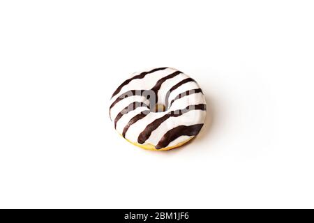 Glazed striped donut on white background, isolated. Party food concept with copy space. Top view. Stock Photo
