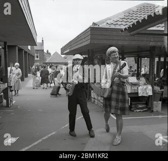 Musicians busking in market, South Elmsall, West Yorshire, Northern England, in 1990 Stock Photo