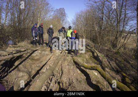 a bridge over a ravine, people build a bridge in the forest, handmade bridge, Russia, Kaliningrad region, Kaliningrad, March 15, 2020 Stock Photo