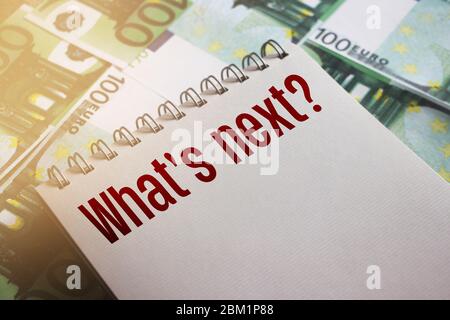 What's next words on page of copybook put on 100 Euro banknotes. Selective focus. Future expectations business startup concept Stock Photo