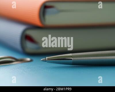 In office on folder are diaries and silver pen Stock Photo