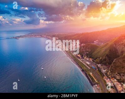 Taormina, Sicily Italy sunset, volcano Etna in clouds. Aerial top view, drone photo. Stock Photo