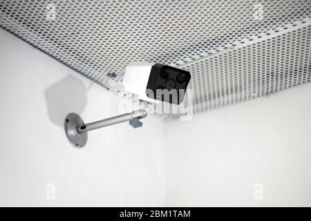 CCTV camera are installed on the wall. Security cam is in white interior background. Stock Photo