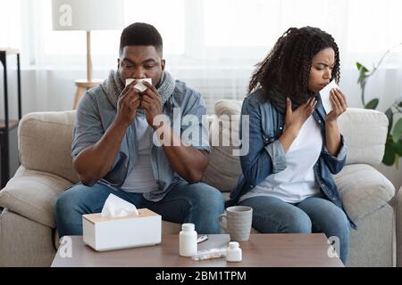 Coronavirus Disease. Sick Black Couple Suffering From Covid-19 Infection At Home Stock Photo