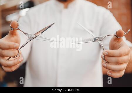 Barbershop Close-up of barber holds hair clipper Stock Photo