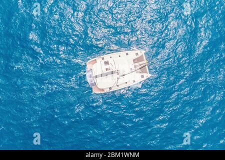 Top view white yacht catamaran stands blue sea water. Concept travel Stock Photo