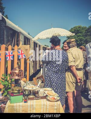 Retro vintage view of re-enactors in 1940s dress at Arley vintage train station for Severn Valley Railway 1940s WWII wartime summer event, UK. Stock Photo