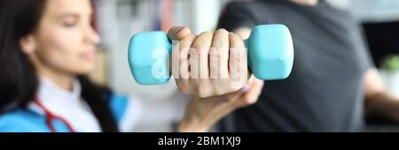Man on stroller doing exercises with dumbbells Stock Photo
