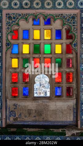 A decorated coloured glass window in the City Palace, Udaipur, India Stock Photo