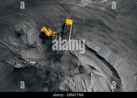 Open pit mine, coal loading in trucks, transportation and logistics, top view aerial Stock Photo