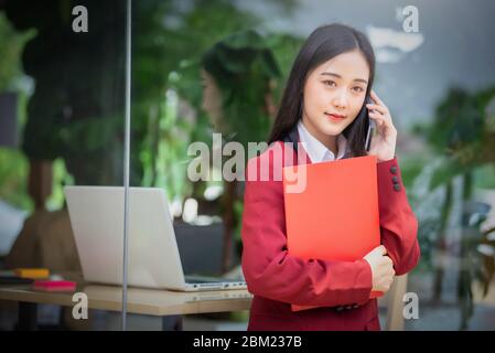 Portrait of Young asian businesswoman using smart phone in cafe. Business success concept. Stock Photo