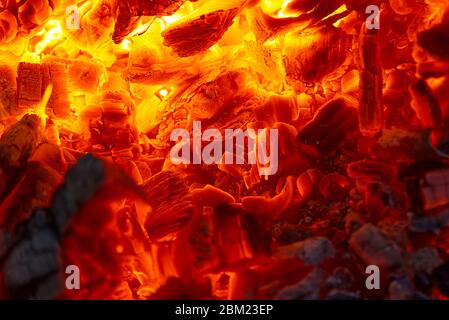 red hot coals in a blast furnace for metal melting. metal mining and processing industry. Red coals from a burnt fire made of wood Stock Photo