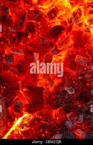 red hot coals in a blast furnace for metal melting. metal mining and processing industry. Red coals from a burnt fire made of wood Stock Photo