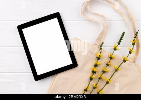 Food grocery online shopping delivery. Eco friendly natural bag and tablet on wooden table Stock Photo