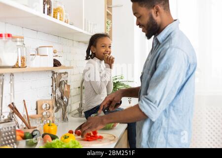 Father and daughter preparing healthy food together at home Stock Photo